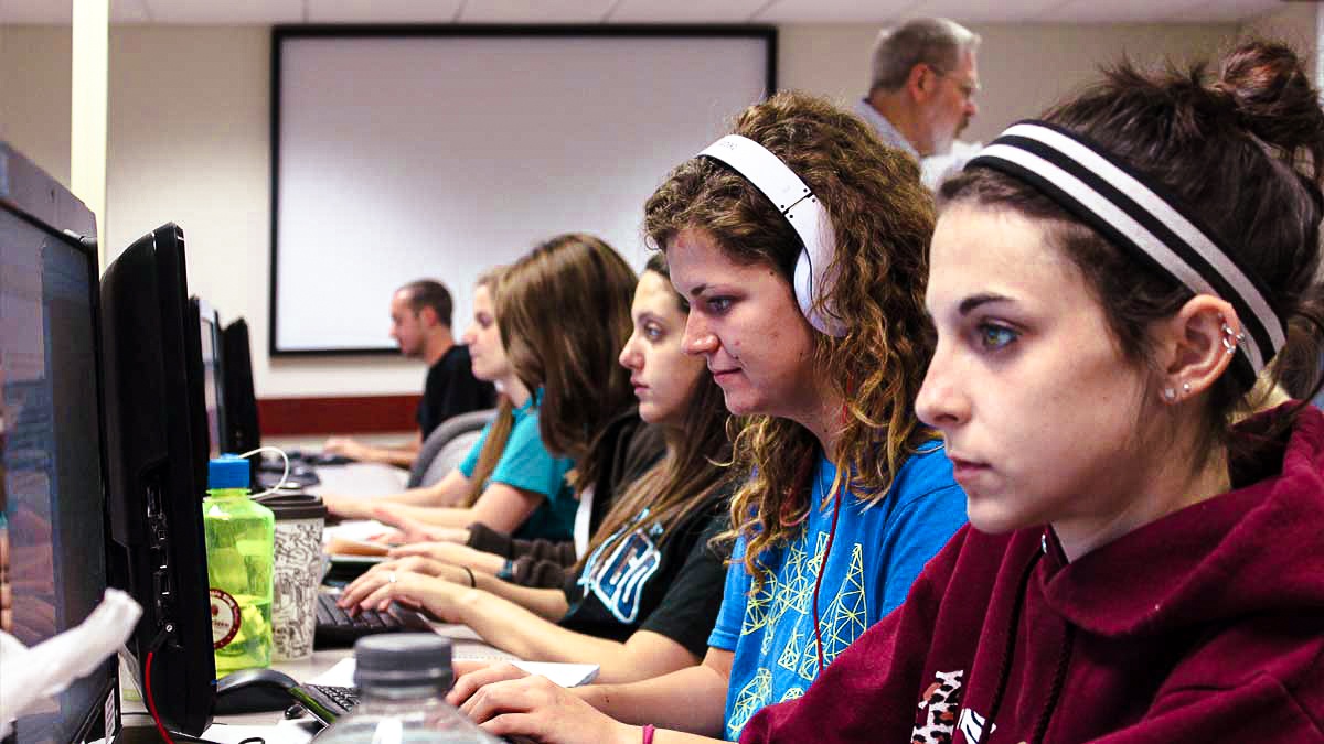 Students working at desktop computers in a computer lab