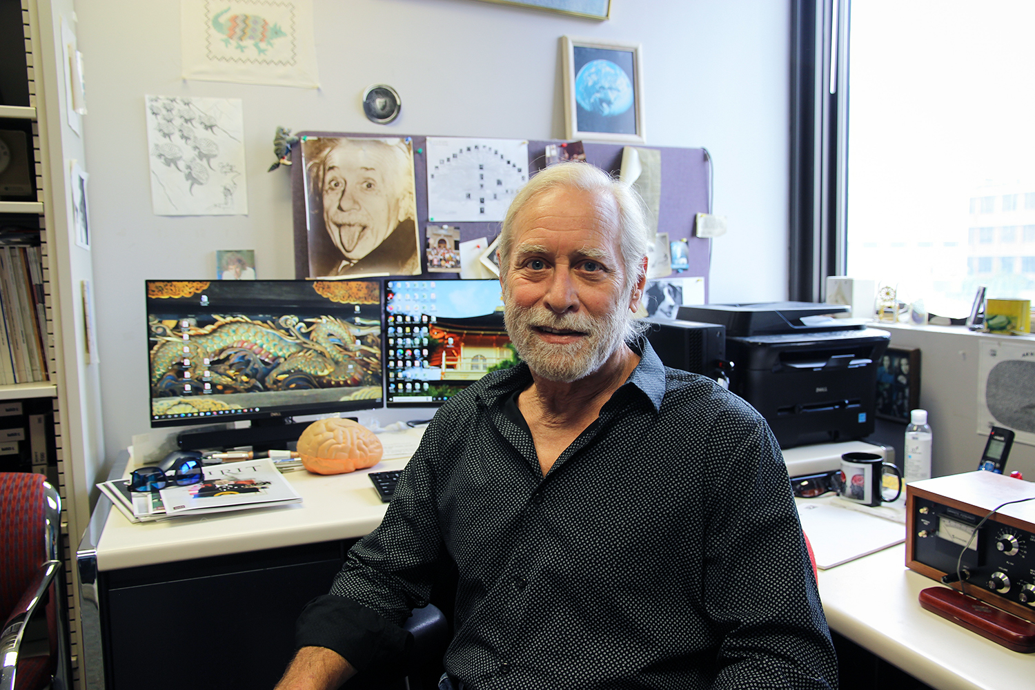 Texas A&M psychology and brain sciences professor Steven Smith, sitting at his desk in his campus office