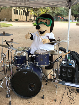 The Chemistry mole playing drums during the Texas A&M Chemistry Open House