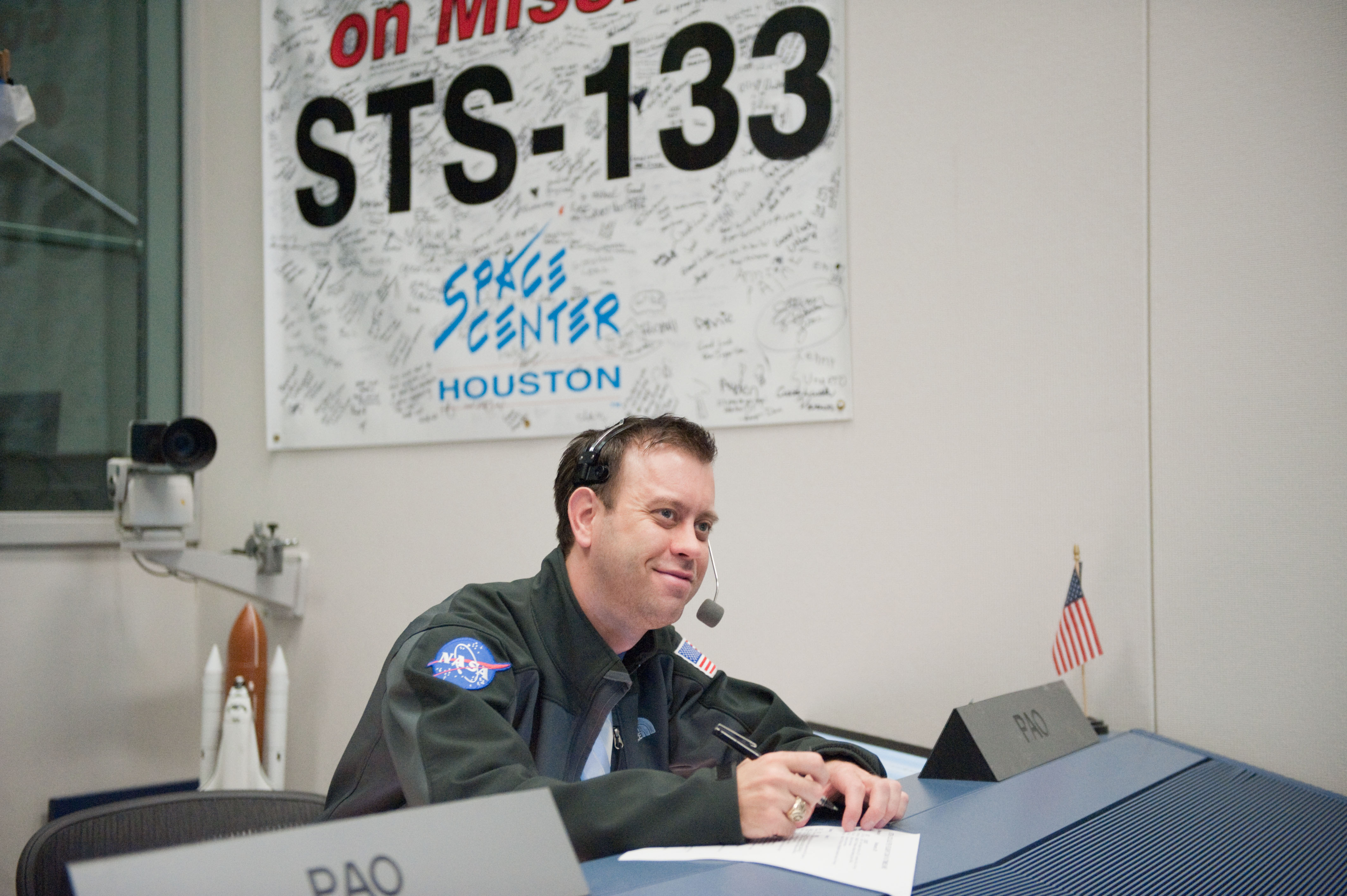 1999 Texas A&M journalism graduate Josh Byerly, wearing a headset and with pen and paper at the ready in his role as Public Affairs Officer and the voice of NASA for STS-133 and the final launch of Space Shuttle Discovery in 2011