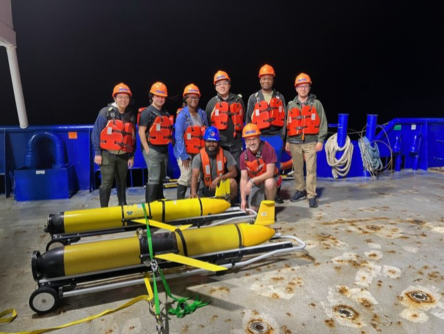 A group of researchers including Texas A&M professor and chief scientist Steven DiMarco on the deck of the R/V Pelican with two Teledyne-Webb Slocum buoyancy gliders