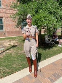 Texas A&M senior Grace Vaughn flashes a gig 'em while posing in her Corps of Cadets uniform on the Quad