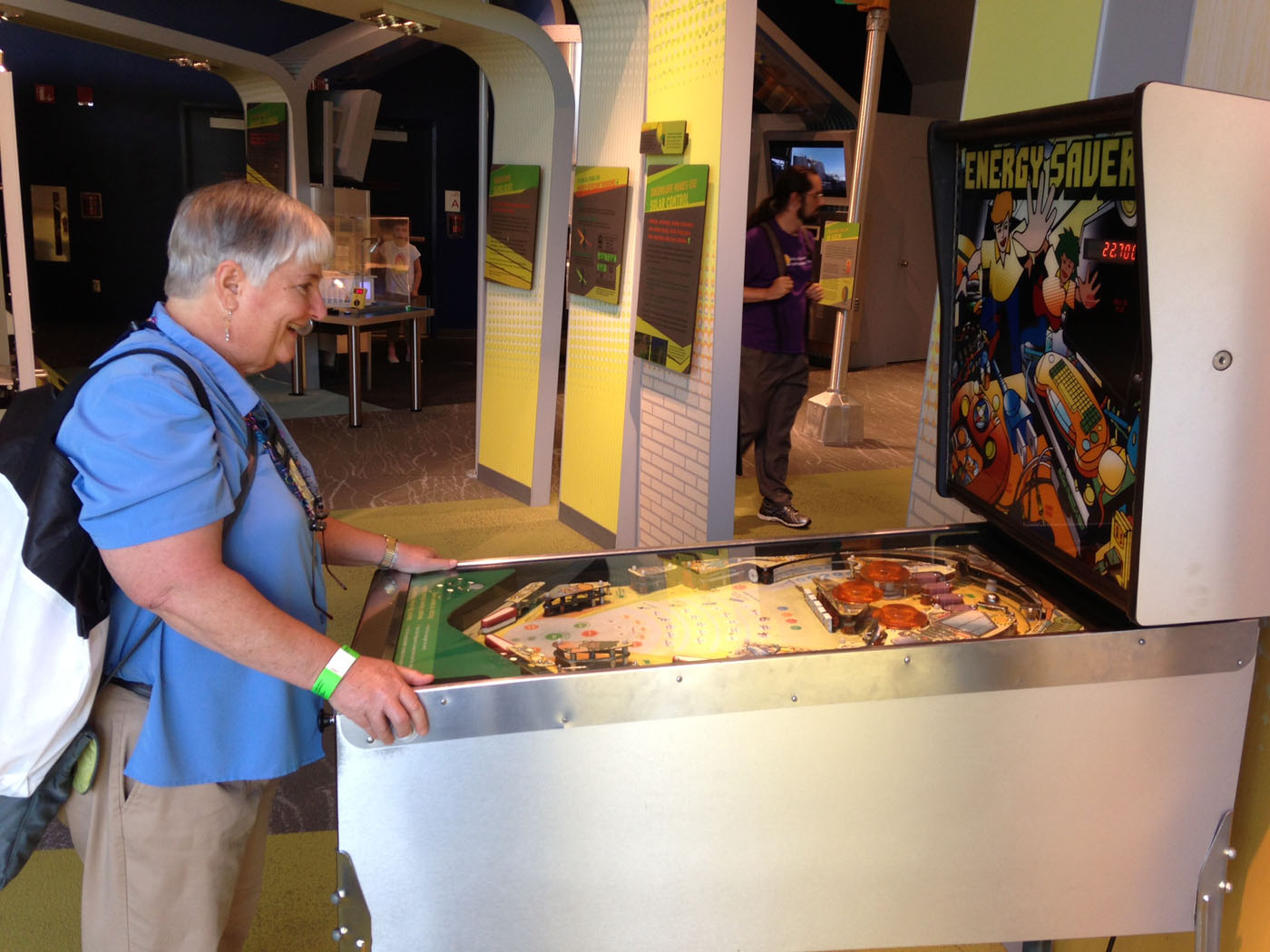 Texas A&M mathematician Sue Geller smiles while playing pinball at MathFest 2013