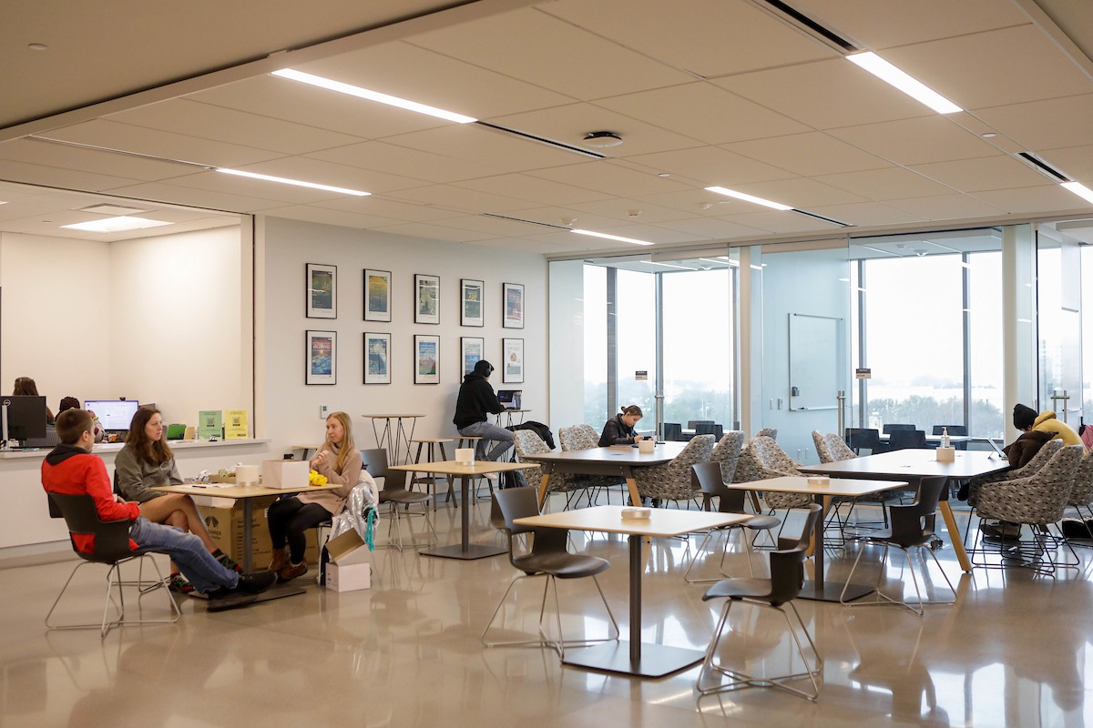 Students working at tables adjacent to chemistry help desk in the Instructional Laboratory and Innovative Learning Building at Texas A&M University