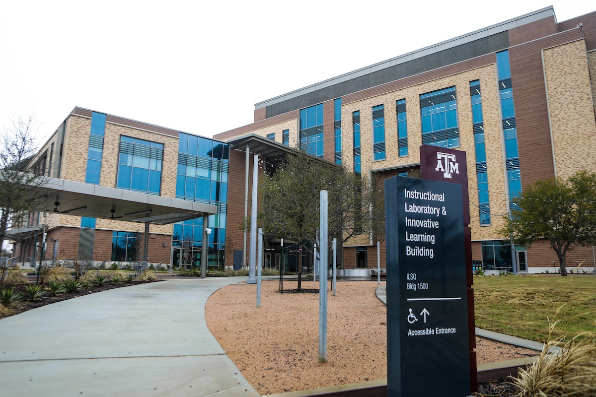 Exterior view of the Instructional Laboratory and Innovative Learning Building at Texas A&M University showcasing the front lawn and outdoor study space located on the building’s south side