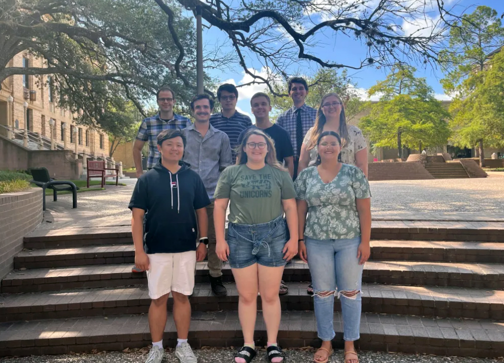 Texas A&M chemist Daniel Tabor and his research group, pictured outside the Chemistry Building on the Texas A&M University campus