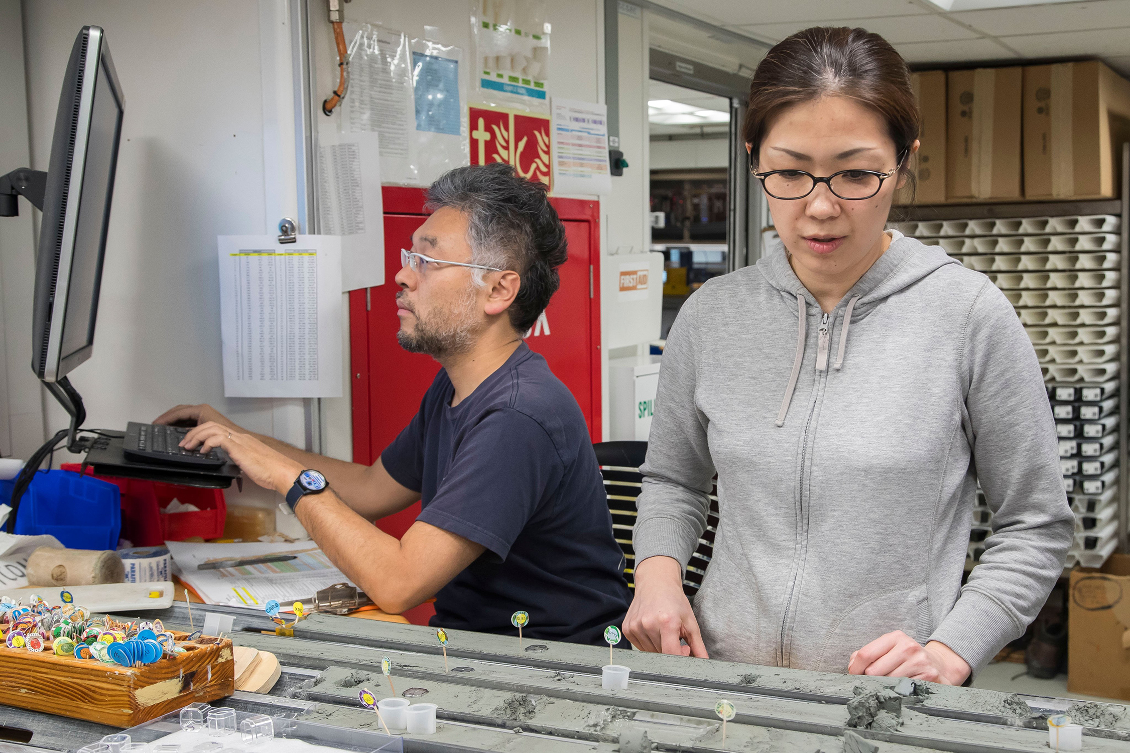Texas A&M geologist Hiroko Kitajima examines core samples taken from the ocean floor while onboard the JOIDES Revolution