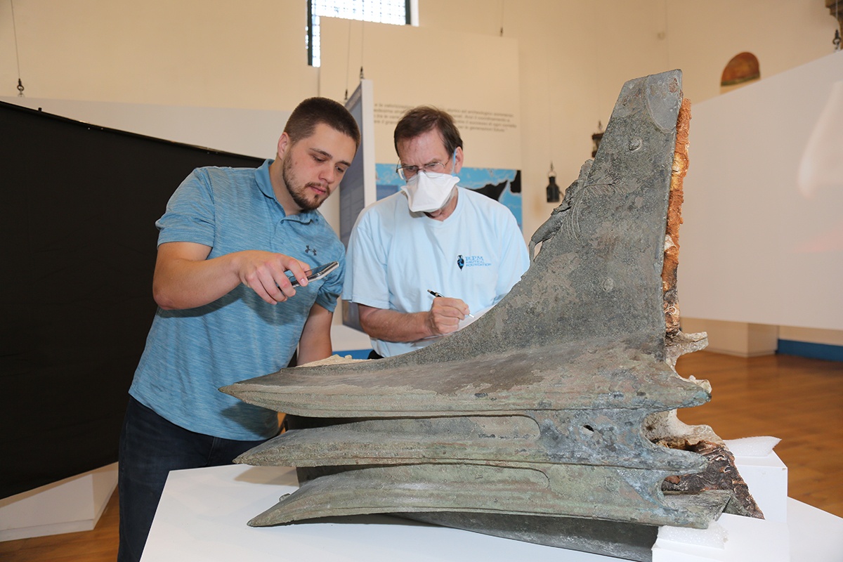 Texas A&M anthropology Ph.D. student Stephen DeCasien studies a naval ram from the Battle of Egadi Islands Project while in Sicily in the summer of 2022