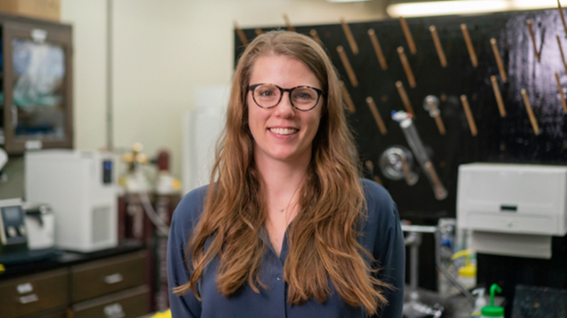 Texas A&M chemist Emily Pentzer smiles for the camera within her laboratory in the Texas A&M Chemistry Building
