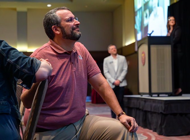 Texas A&M chemist Daniel Collins, holding hands with his fiancé Dr. Sara Fehr while awaiting presentation of his 2023 Outstanding Advocate for First-Year Students Award