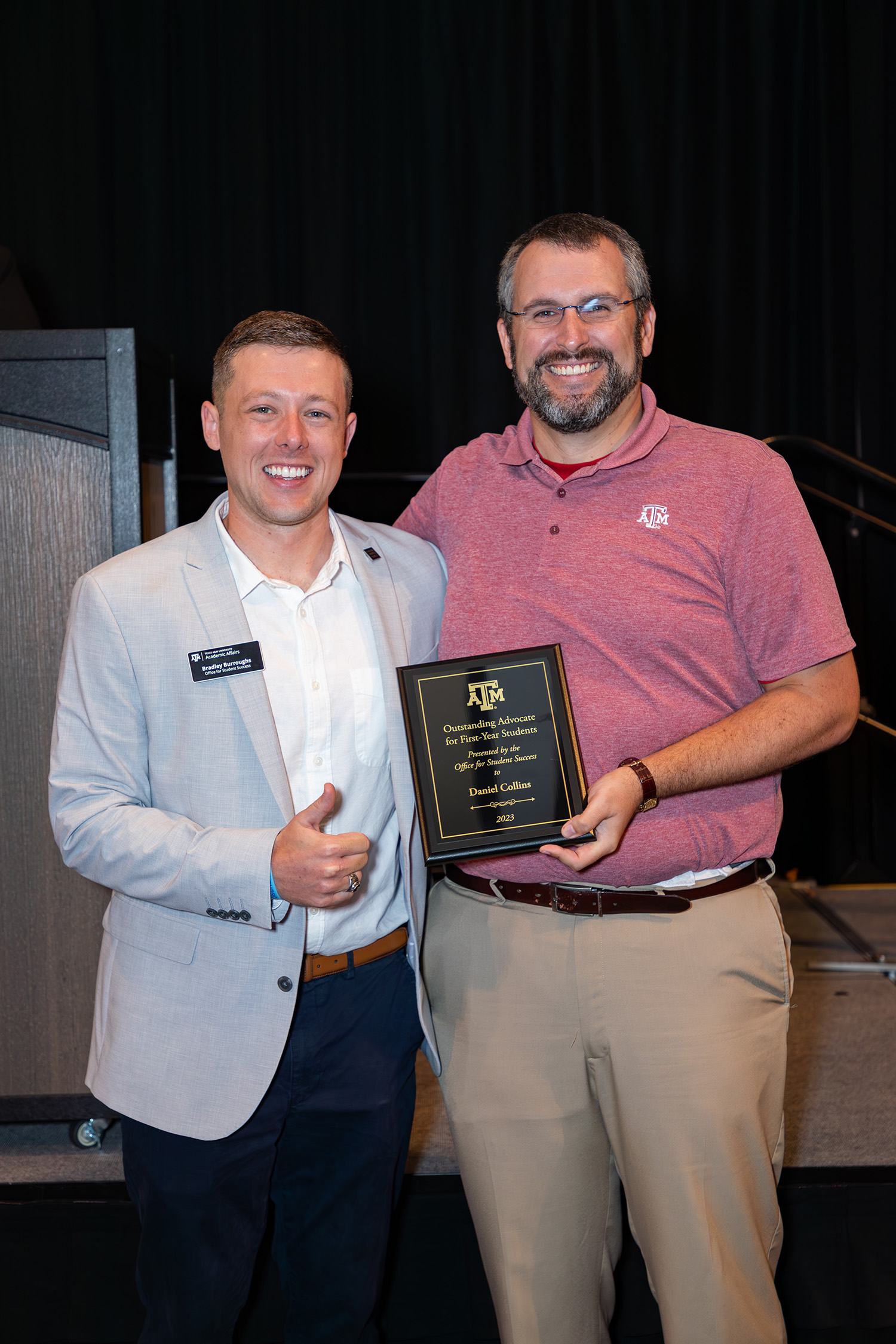 Texas A&M chemist Daniel Collins (right) receives congratulations from the Office for Student Success's Bradley Burroughs upon Collins' receipt of the 2023 Outstanding Advocate for First-Year Students Award