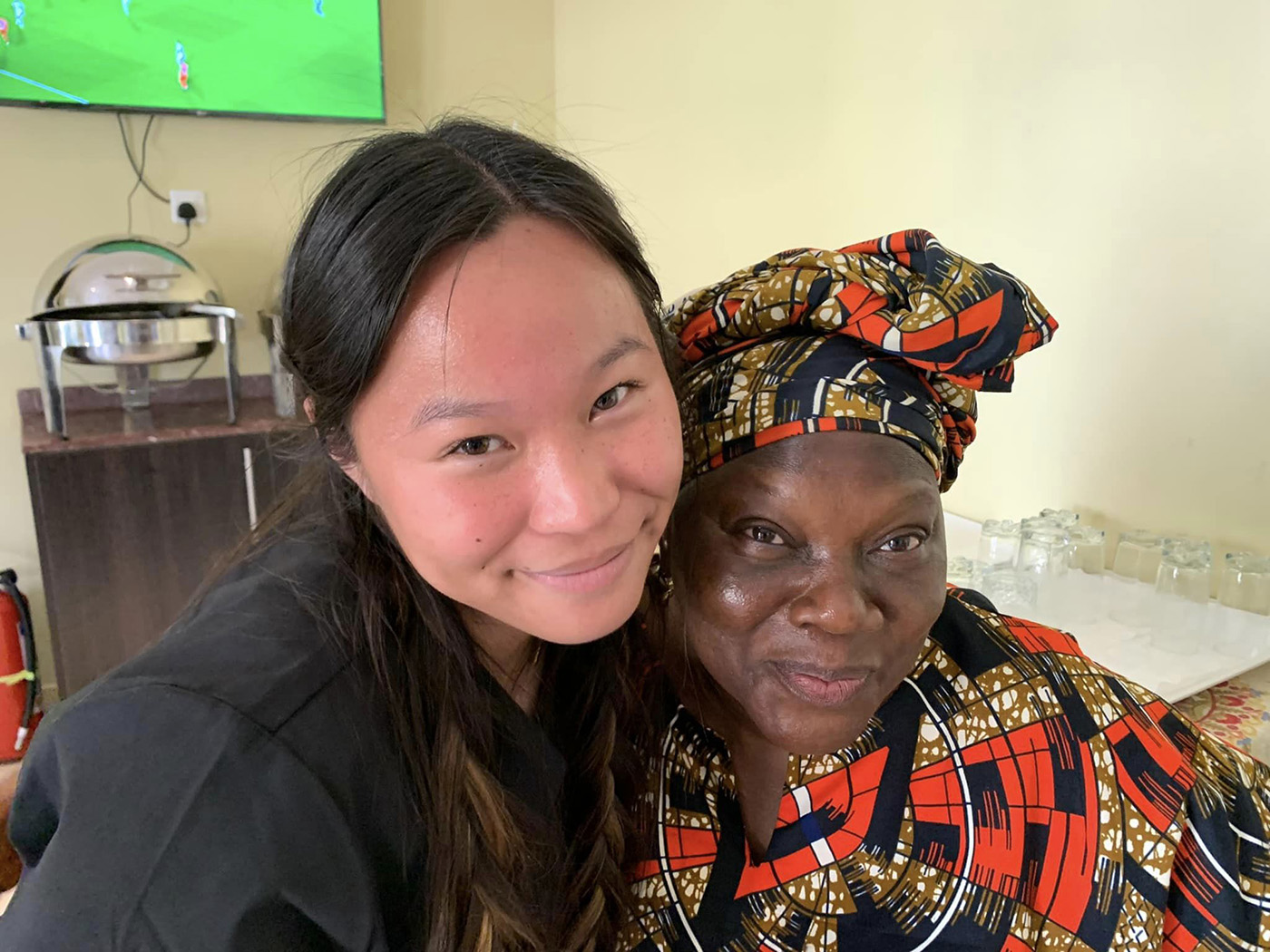 Texas A&M biomedical sciences major Mya Phelps poses with the cook in Nigeria in May 2022
