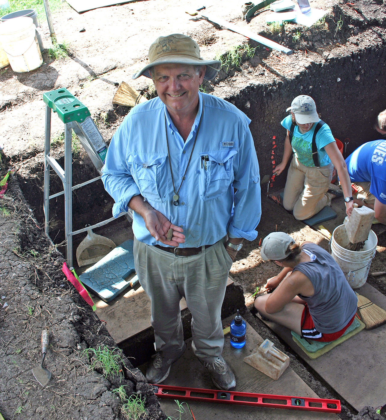 Texas A&M archaeologist Michael Waters holds a complete spear point that he had just found while on a dig in central Texas