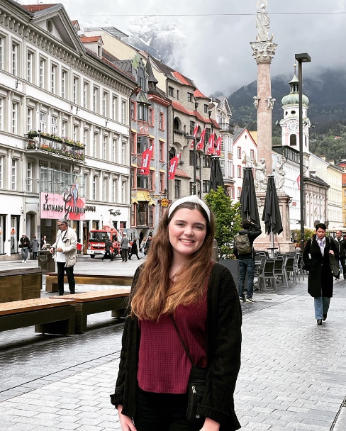 Texas A&M meteorology student Hope Boland smiles for the camera on a street corner in Munich, Germany