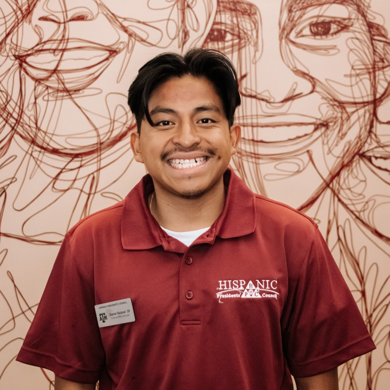Texas A&M psychology major Daniel Salazar poses in front of the Multicultural Services mural in the Memorial Student Center on the Texas A&M University campus