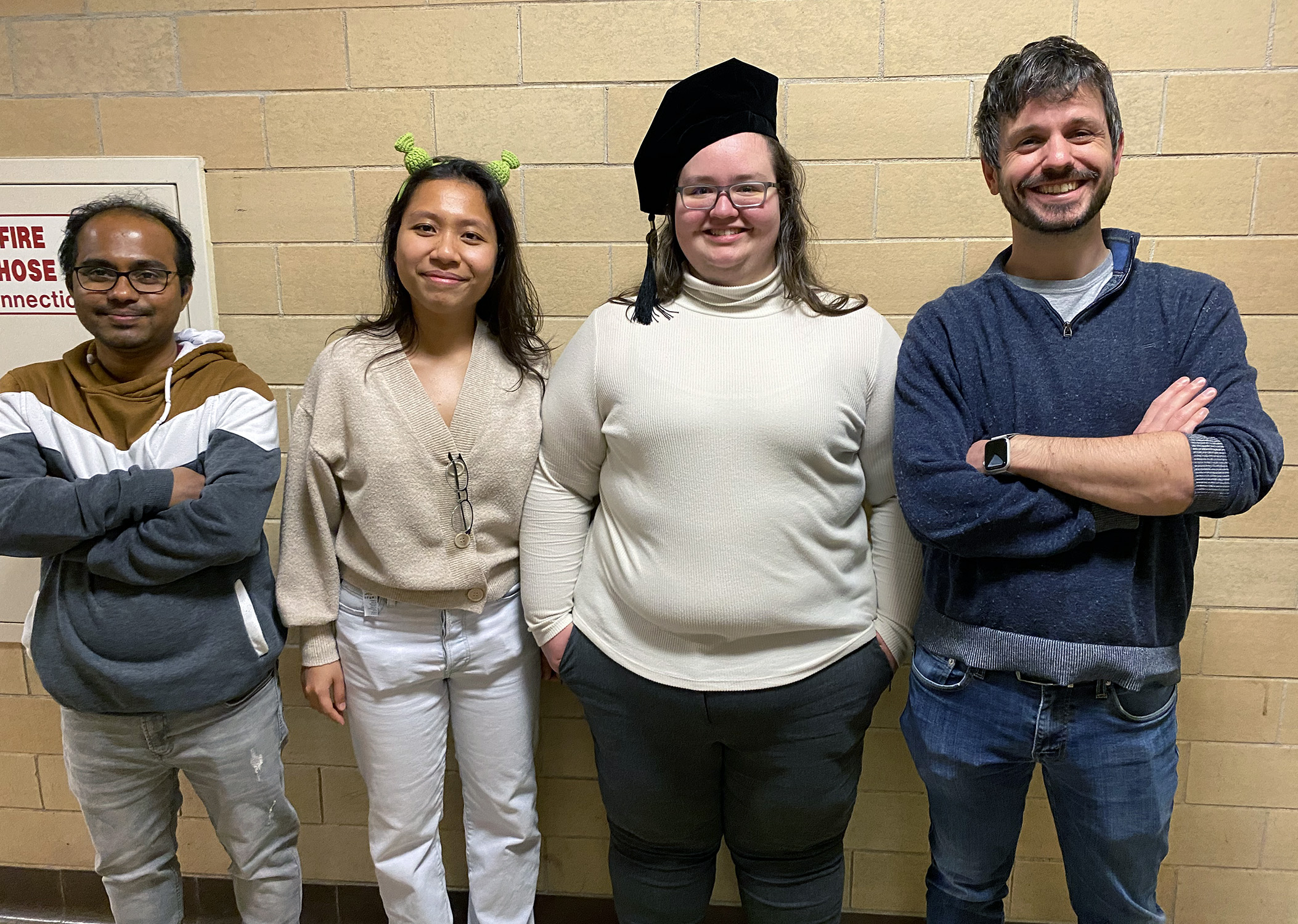 Texas A&M University chemist Quentin Michaudel (right), pictured with Michaudel Laboratory members (from left) Arunava Maity, An Tran and Sarah Hancock at Hancock's doctoral commencement on Dec. 15, 2023.