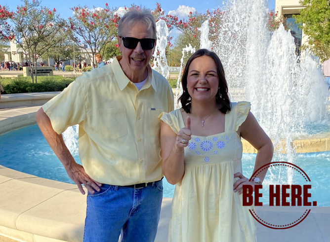 Texas A&M geography senior Mackenzie Portie poses with her grandfather Michael Hoover beside the water fountain outside the Jon L. Hagler Center after receiving her Aggie Ring