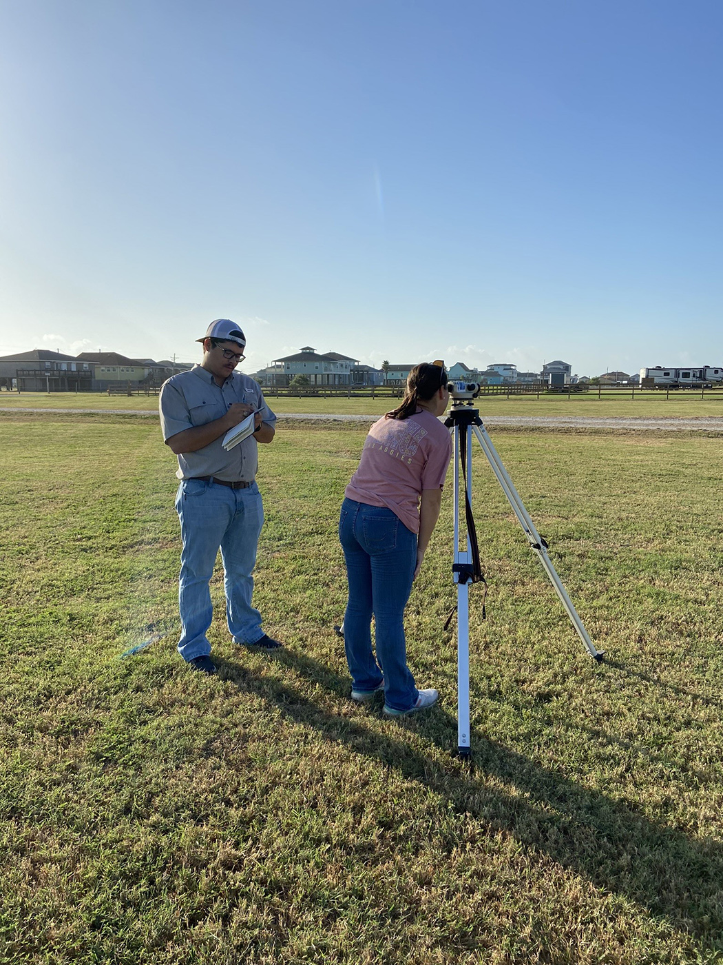 Texas A&M University geography major Mackenzie Portie works on a level loop during filed work in summer 2023
