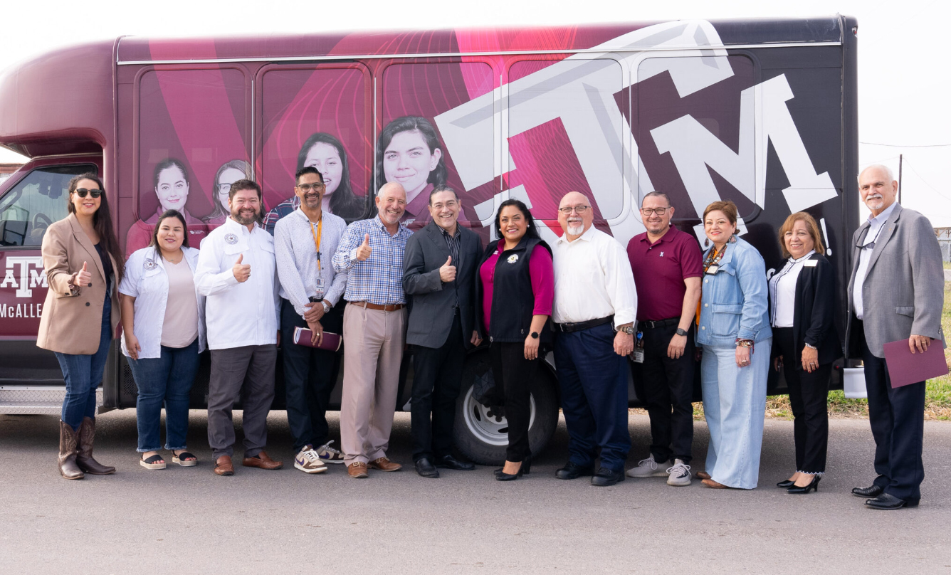 U.S. Census Bureau Director Robert Santos, pictured with a group of Texas A&M University Higher Education Center at McAllen staff and area officials in front of a Texas A&M-McAllen branded van