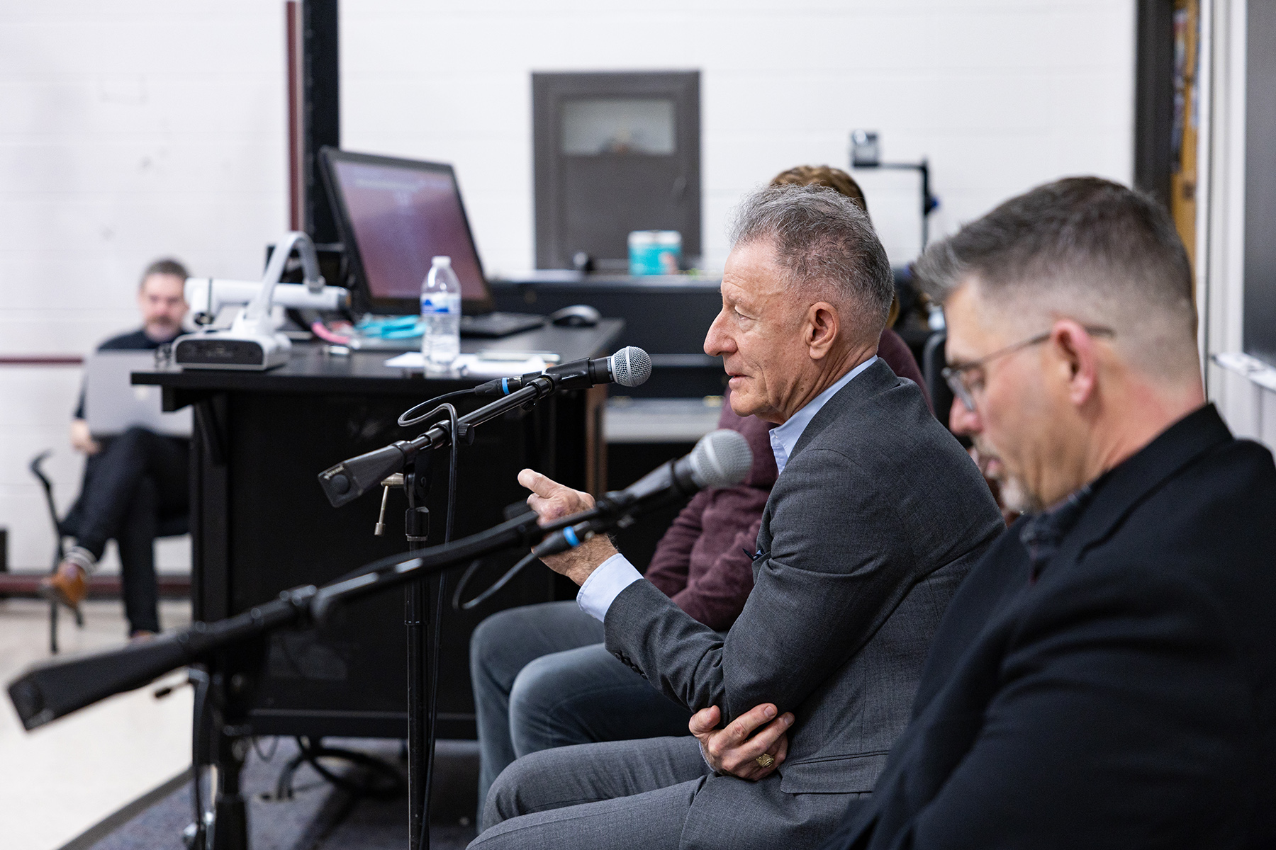 1979 Texas A&M University graduate Lyle Lovett sits at the front of a classroom while speaking to a class full of undergraduates at Texas A&M on Feb. 12, 2024