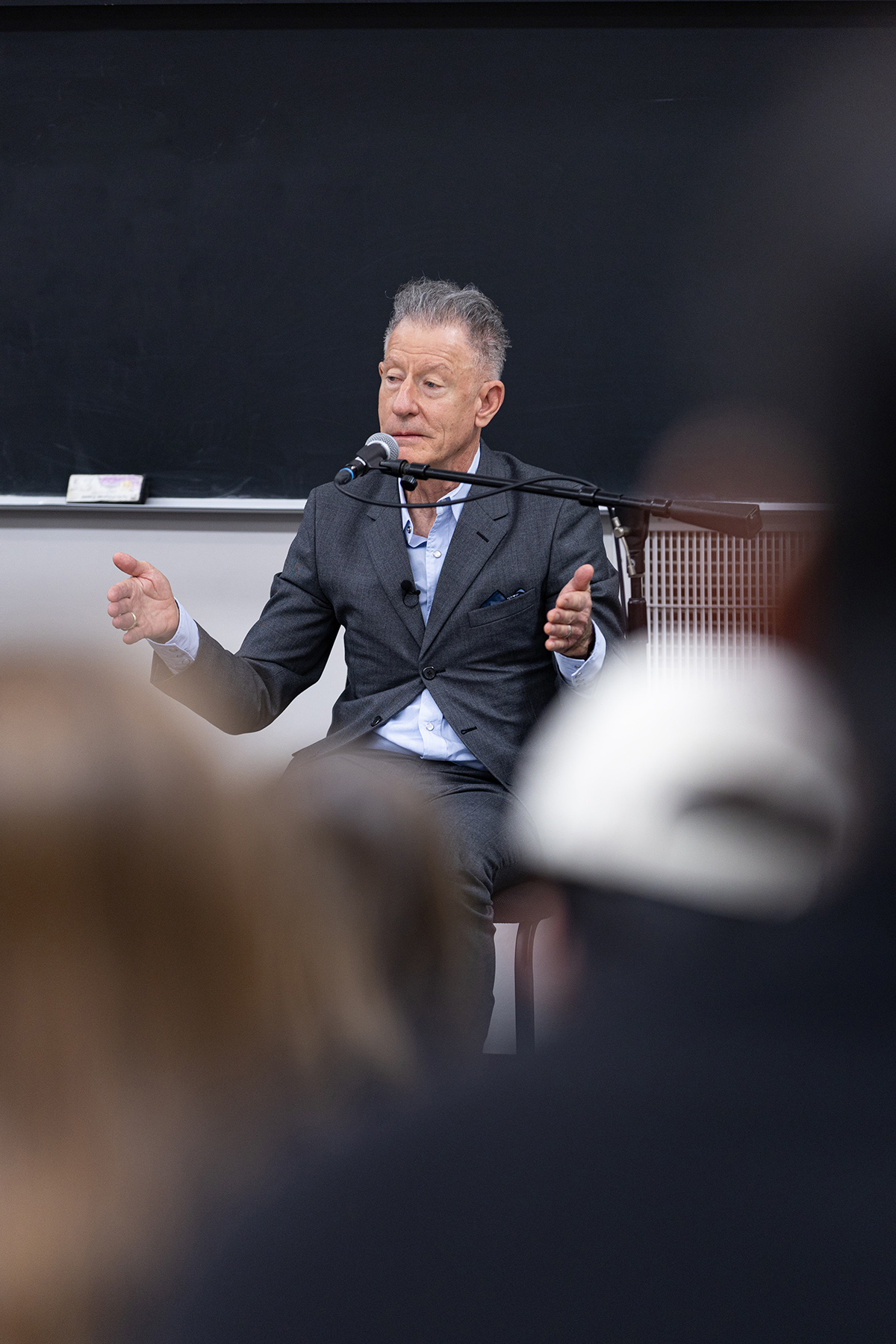 1979 Texas A&M University graduate Lyle Lovett sits at the front of a classroom while speaking to a class full of undergraduates at Texas A&M on Feb. 12, 2024