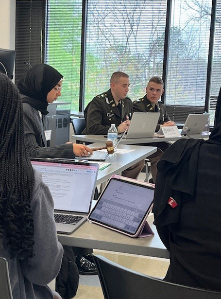 Two Texas A&M University team members (far right), acting as diplomats for Morocco and interacting with other diplomats during the 2024 Model Arab League Conference, held March 2-3 in Houston