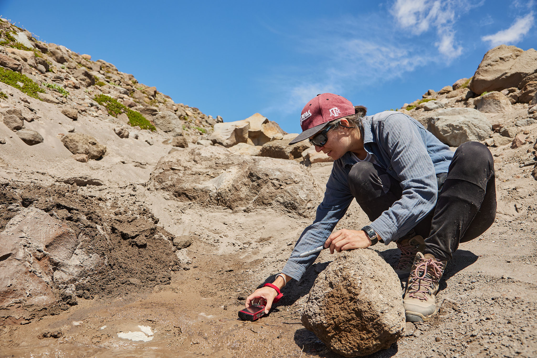 Texas A&M University scientist Marion Nachon drives a small red truck through the soil at Mount Hood in Oregon during field testing in summer 2023