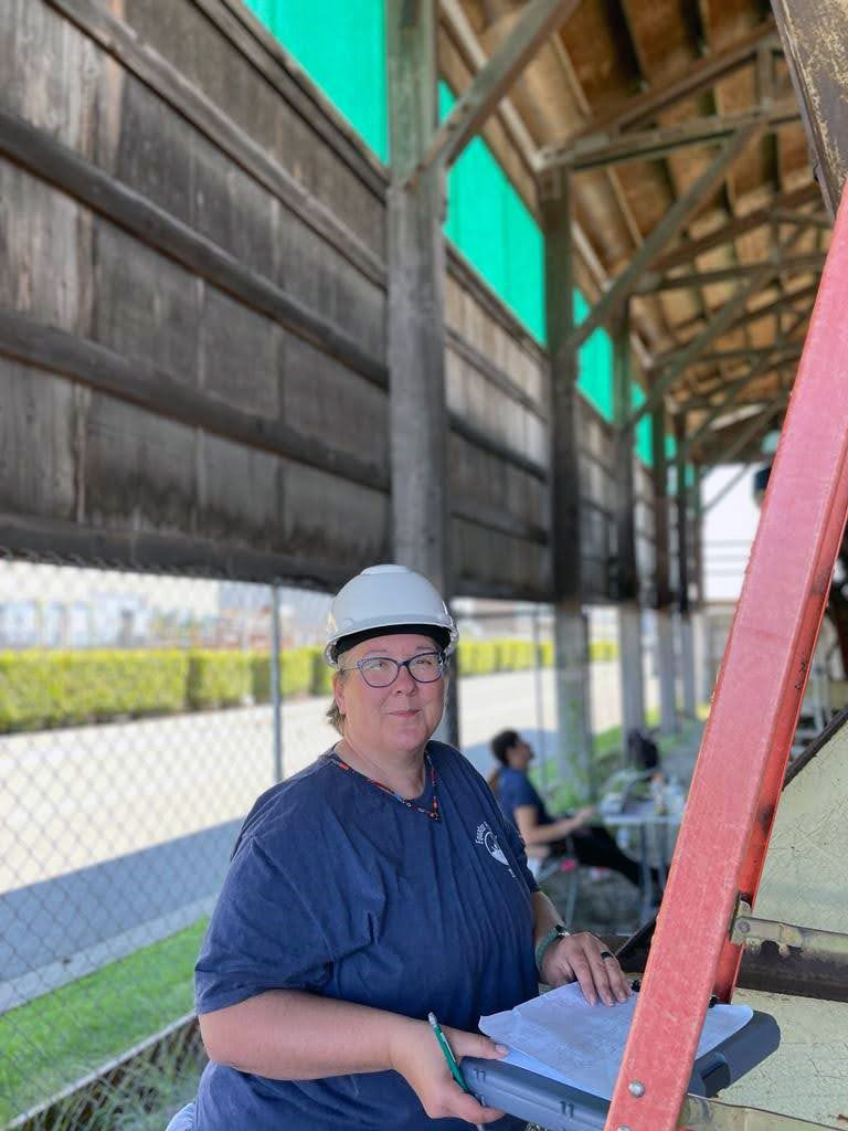 Texas A&M University senior anthropology major Kimberly Price wears a hard hat and takes notes as she works on the Equator in dry dock in Everett, Washington, in 2023