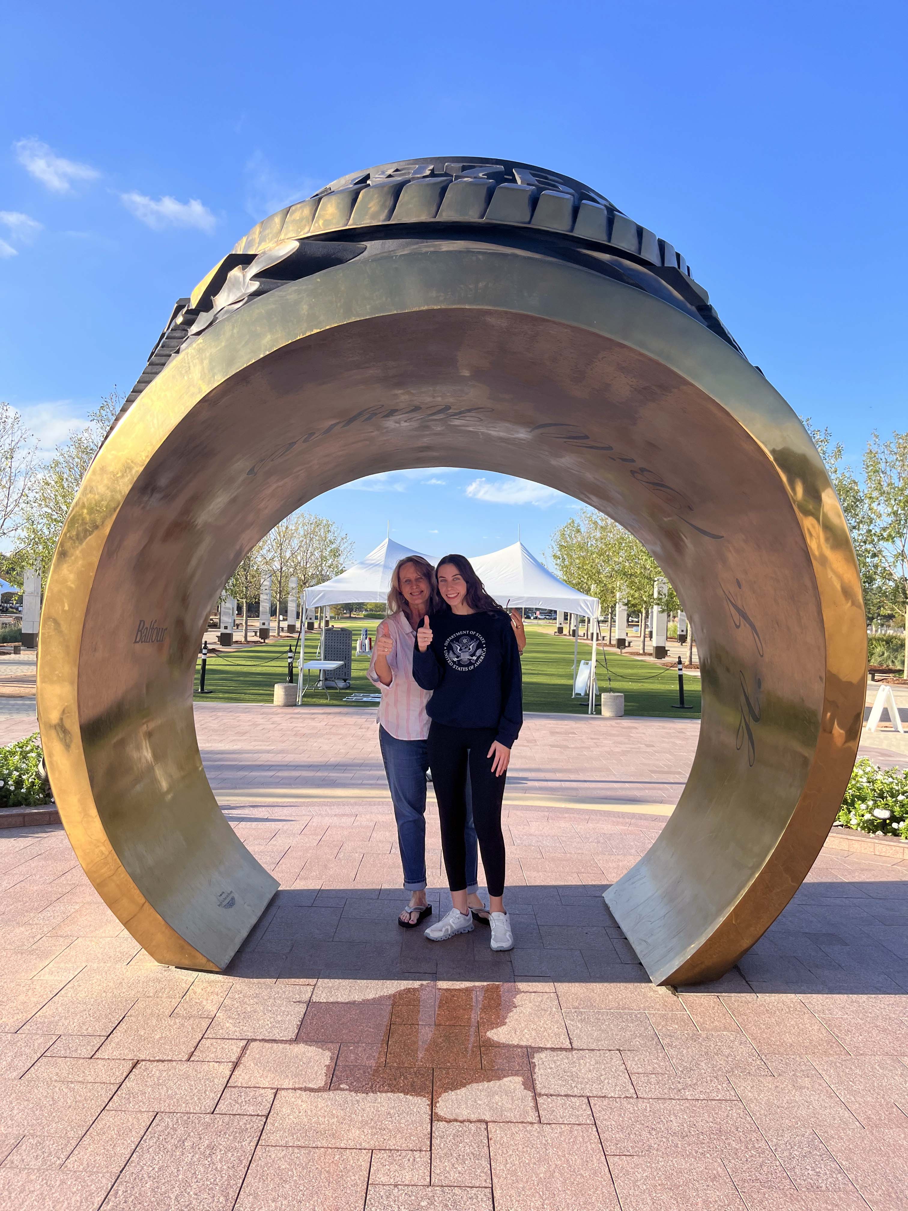 SarahBeth (right) and Shari Boothe pose together inside the giant Aggie Ring outside the Clayton Williams Jr. Alumni Center on the Texas A&M University campus