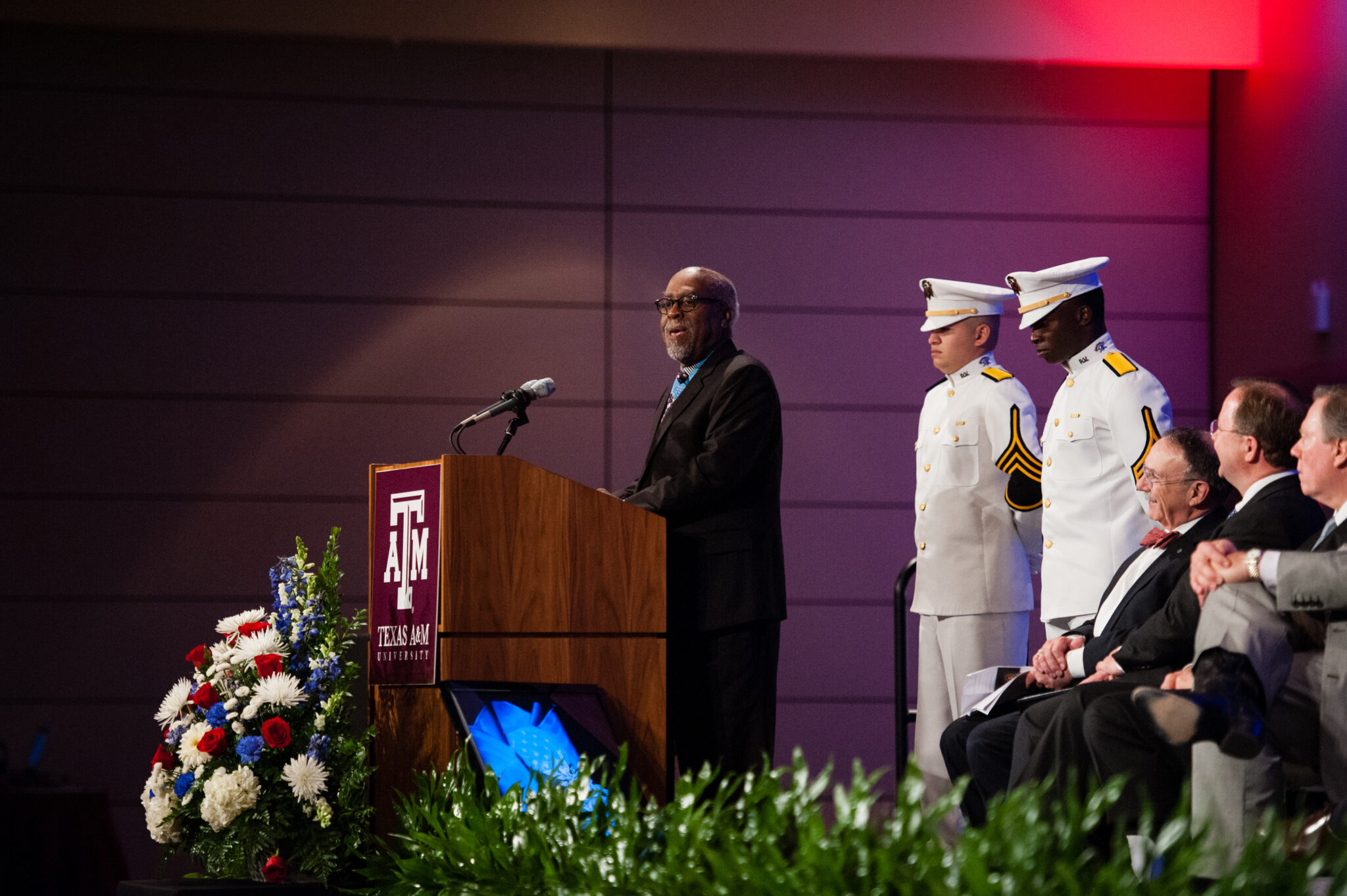 Texas A&M University chemistry former student and Congressional Medal of Honor recipient Clarence Sasser speaks at a podium during his Hall of Honor recognition ceremony, held November 7, 2013, in the Memorial Student Center