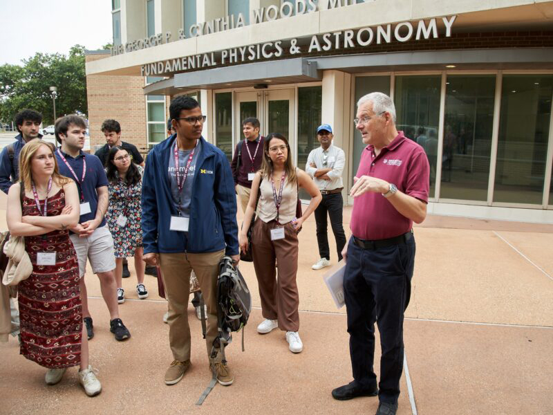 Texas A&M University professor Joerg Steiner talks with students outside the George P. and Cynthia Woods Mitchell Institute for Fundamental Physics and Astronomy who are participating in the Lindau Nobel Laureate Meetings during a campus tour