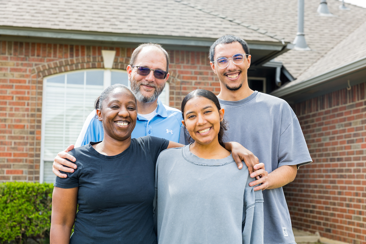 Group photograph of Aria Vargyas and her family (mother Laurinda, father Phillip and brother Damon) outside their home in Moore, Oklahoma