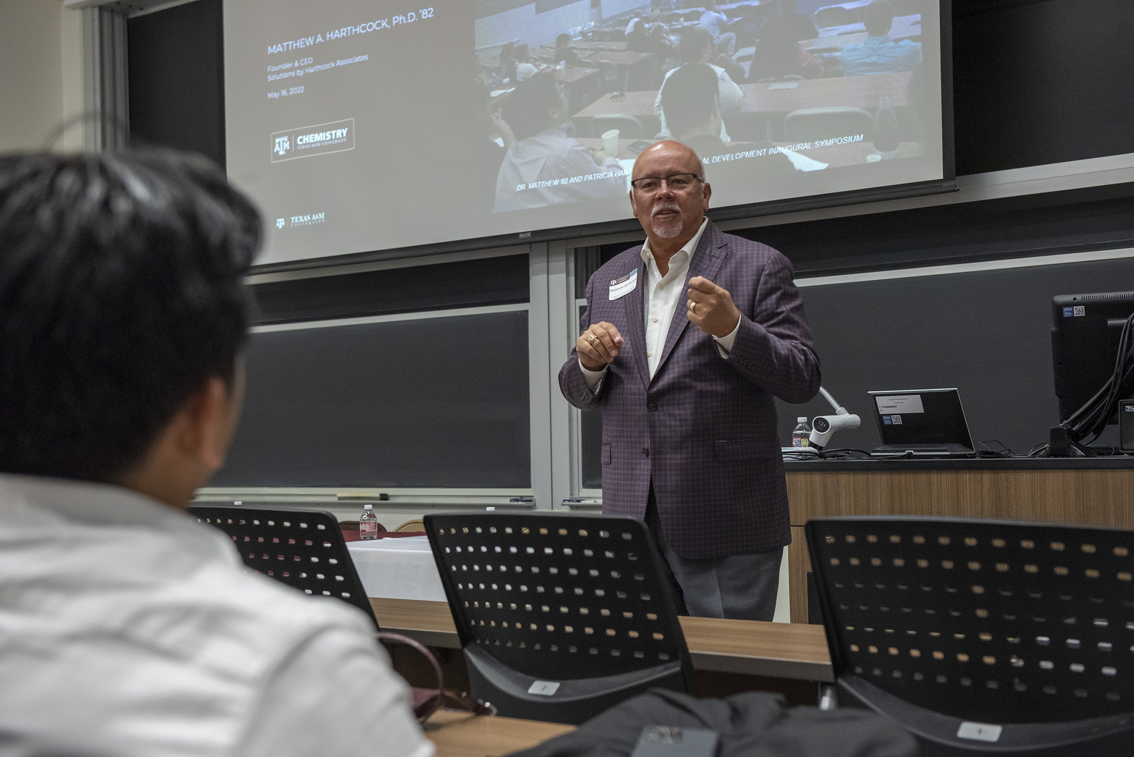 1982 Texas A&M University chemistry graduate Matthew Harthcock presents to a graduate student crowd on the Texas A&M campus