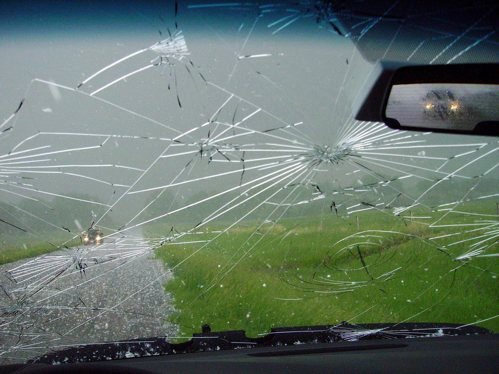 Stormy skies viewed through the cracked windshield of a mobile mesonet vehicle driven by Texas A&M University atmospheric scientist Christopher Nowotarski during the VORTEX2 field project in June 2009 in eastern Wyoming
