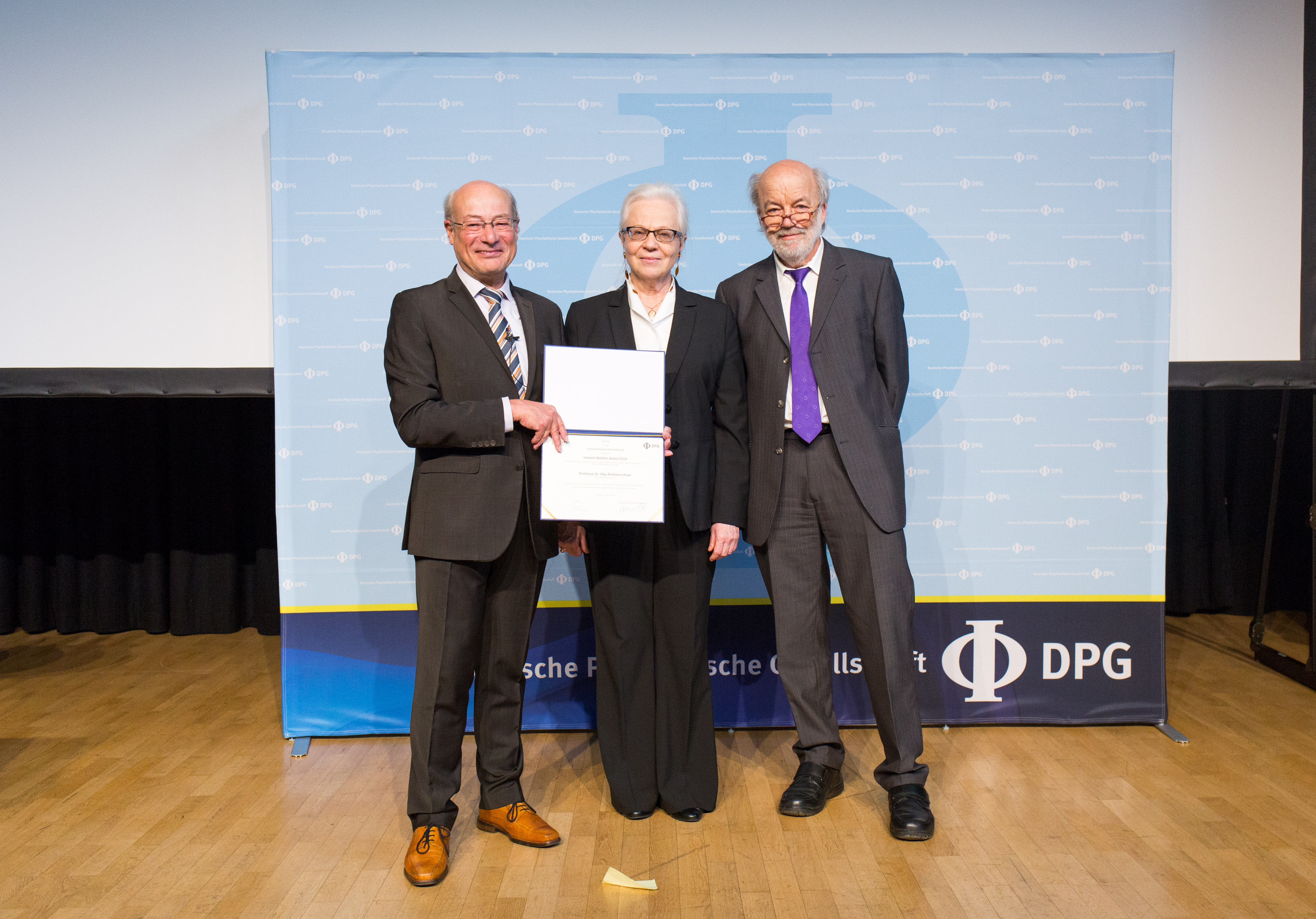 Texas A&M University physicist Olga Kocharovskaya (center) accepts her 2024 Herbert Walther Award honoring pioneering research and leadership from German Physical Society President Jochim Ullrich (left) and Optica President Gerd Leuchs (right) during the German Physical Society meeting in Freiburg, Germany, this past March.
