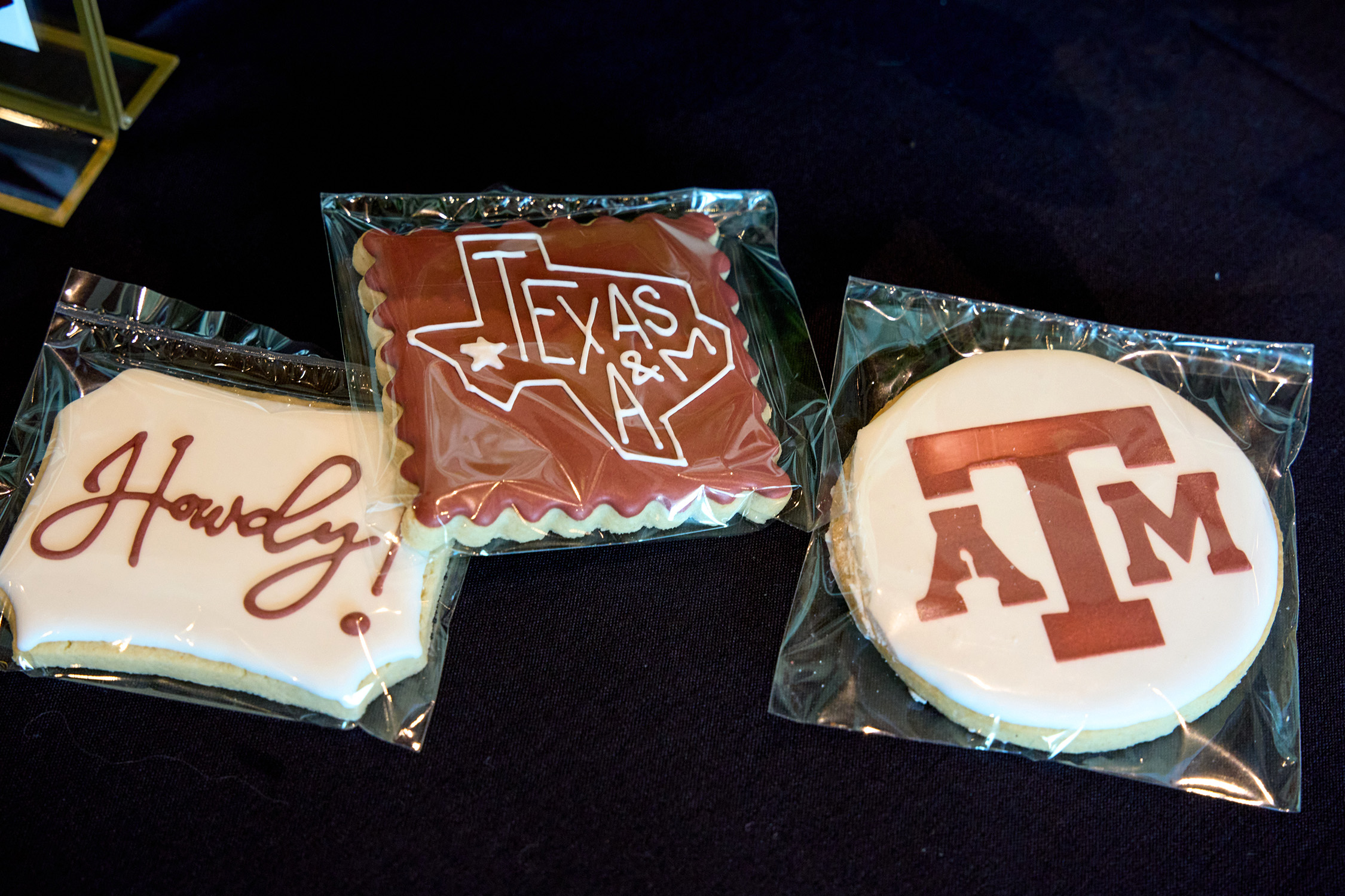 Custom-decorated cookies featuring maroon and white icing and the words "Howdy" and "Texas A&M" and the Texas A&M logo