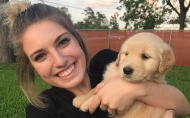 2020 Texas A&M University economics graduate Noelle Levantino and her golden retriever, Charli