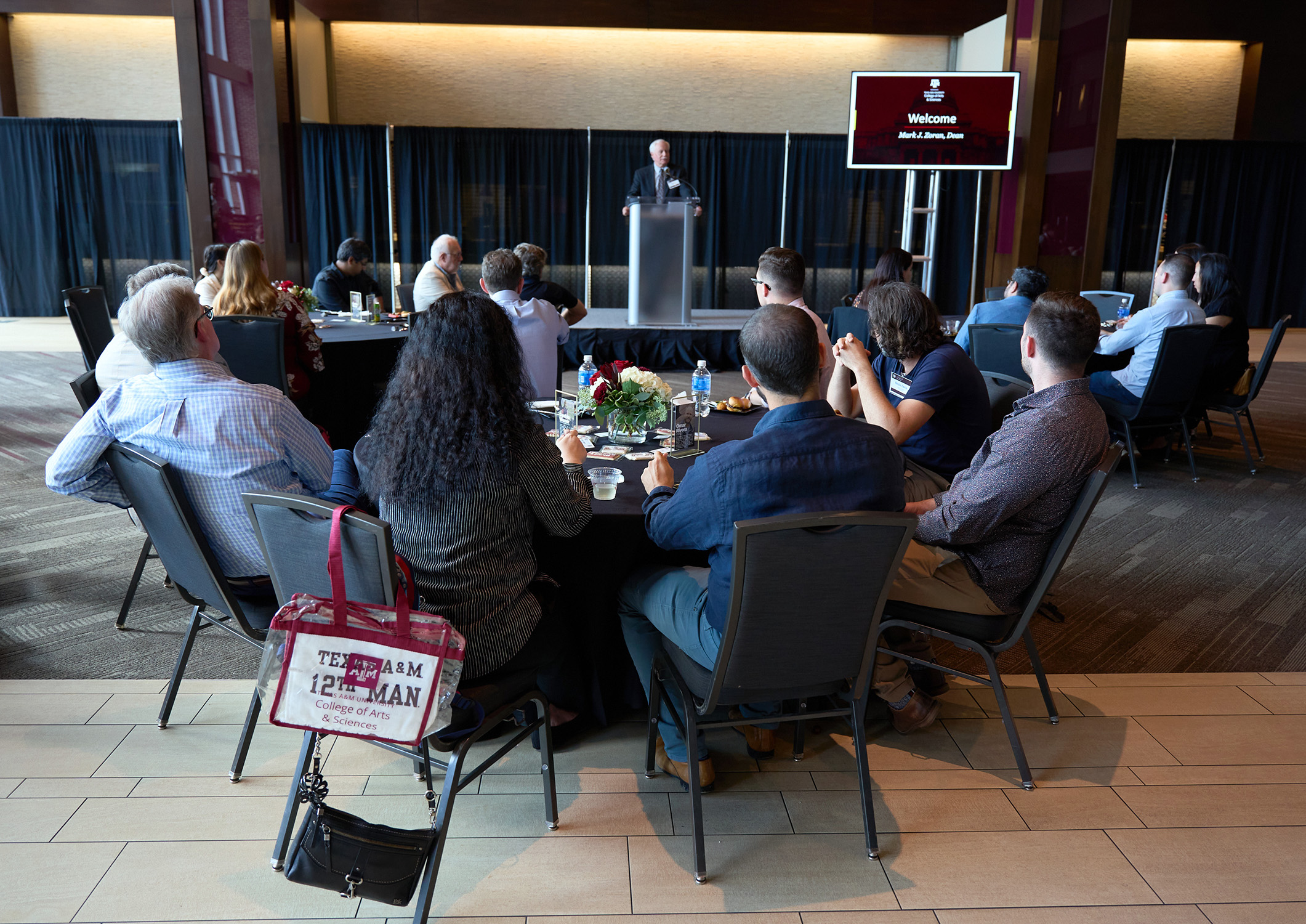 Texas A&M University College of Arts and Sciences Dean Mark Zoran addresses the crowd from behind the podium in the All-American Club at Kyle Field during the 2024 College of Arts and Sciences New Faculty Welcome Reception on September 12, 2024