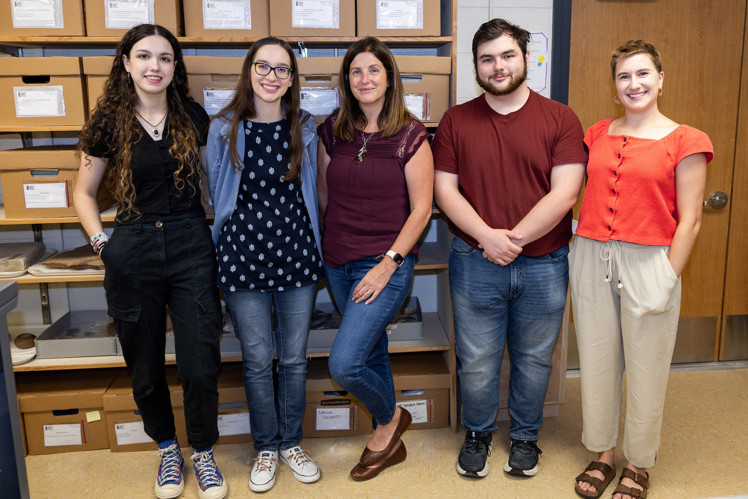 Group photograph of Texas A&M University Anthropology Research Collections staff (from left) Lily Dempsey, Bradie Dean, Dr. Katie Custer Bojakowski, Jason Brickley and Emma Newman, taken within the ARC on October 1, 2024