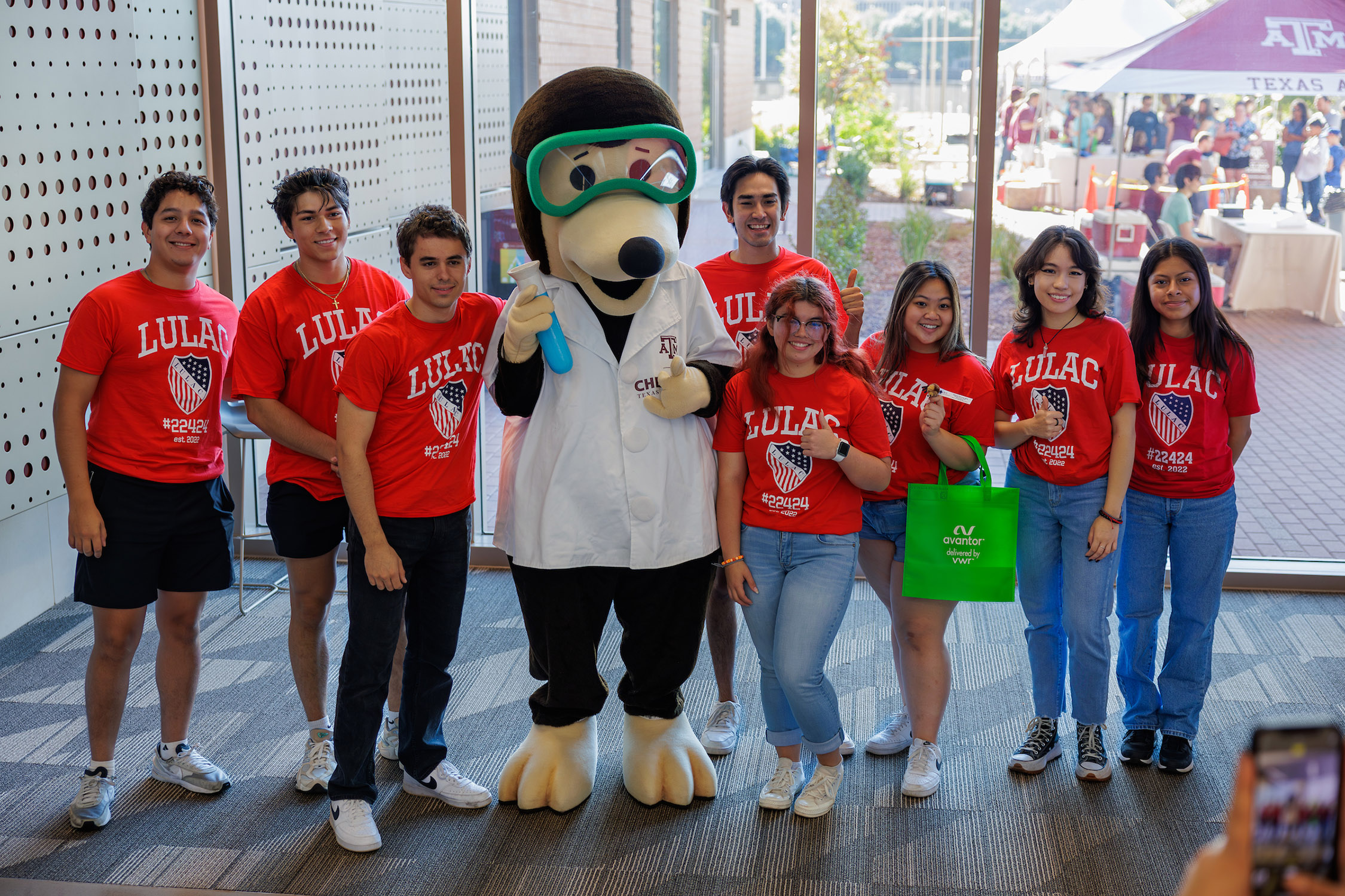 The Texas A&M Chemistry mole poses with a group of school kids at the 2023 Chemistry Open House