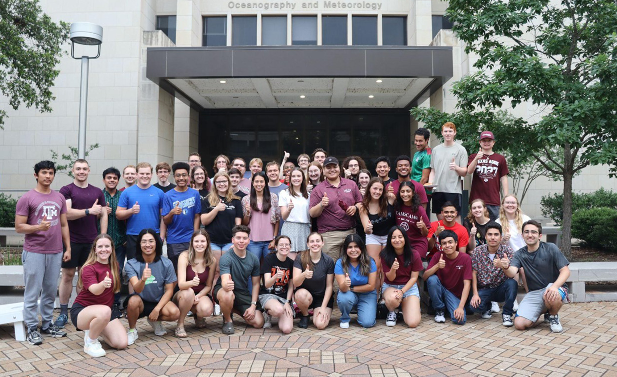 A group of TAMSCAMS students standing in front of the Oceanography and Meteorology building at Texas A&M University. The photo is from May 2024