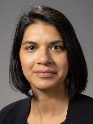 Portrait of Sarah Zubairy, featuring a close-up of her face with a neutral expression against a gray background.
